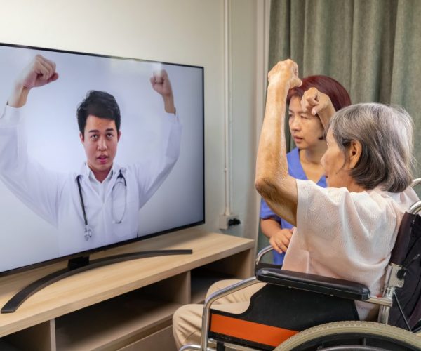 Elderly woman using physical therapy online service at home.